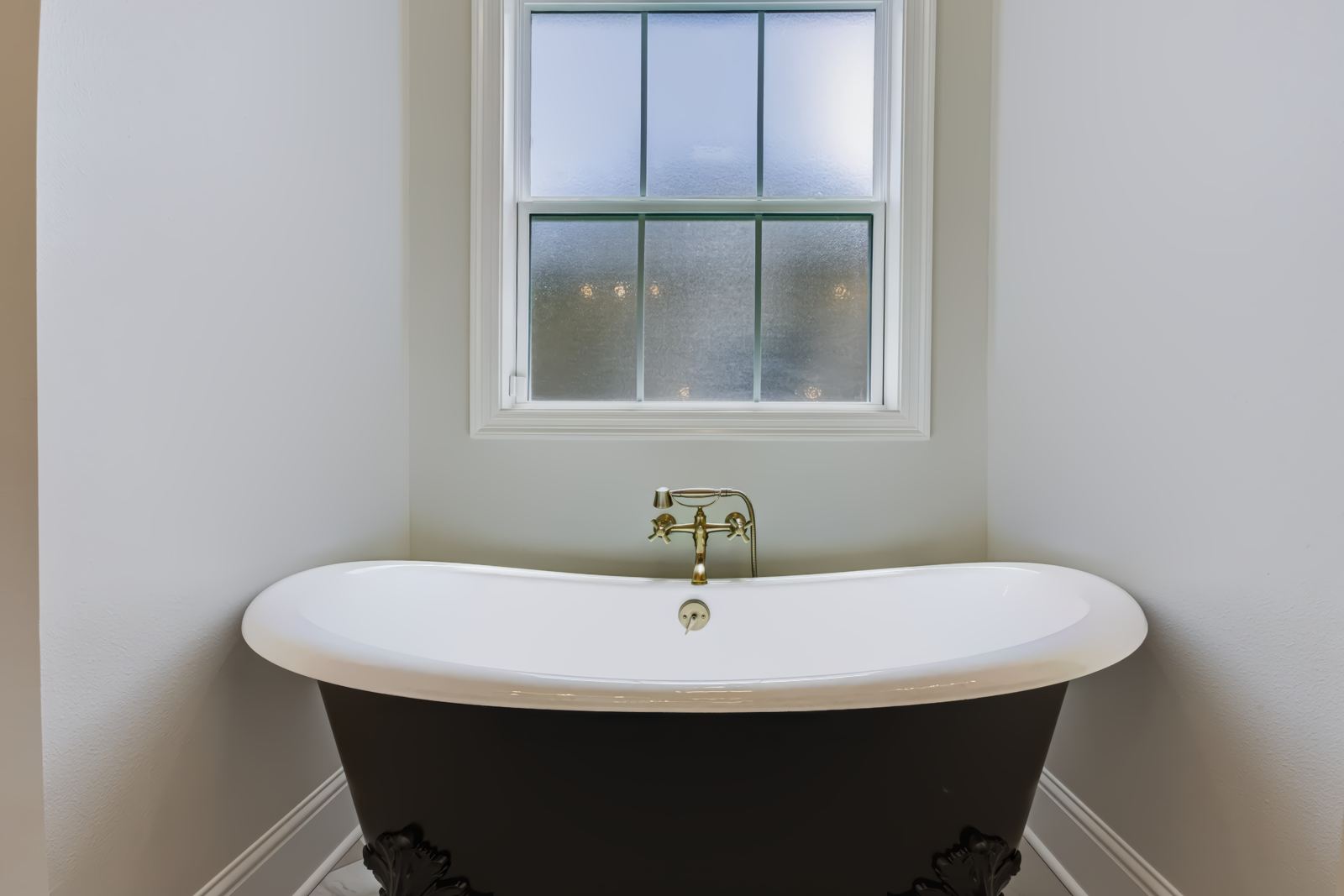 Bathroom with freestanding black clawfoot tub