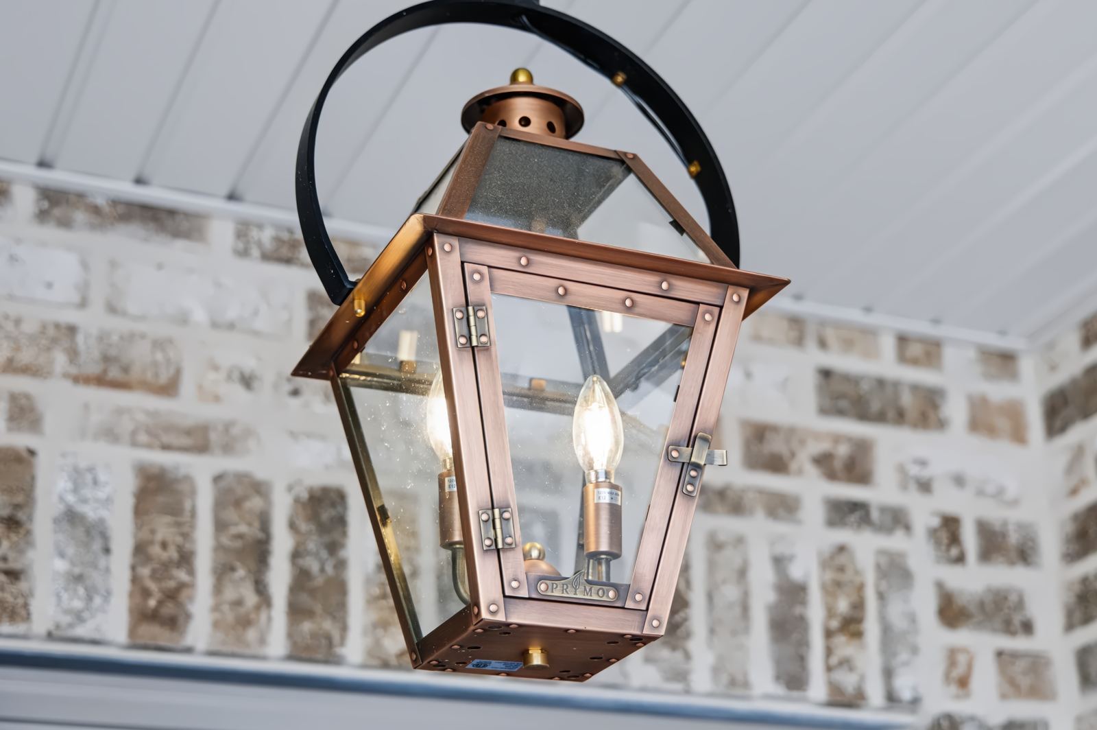 Copper lantern detail on brick