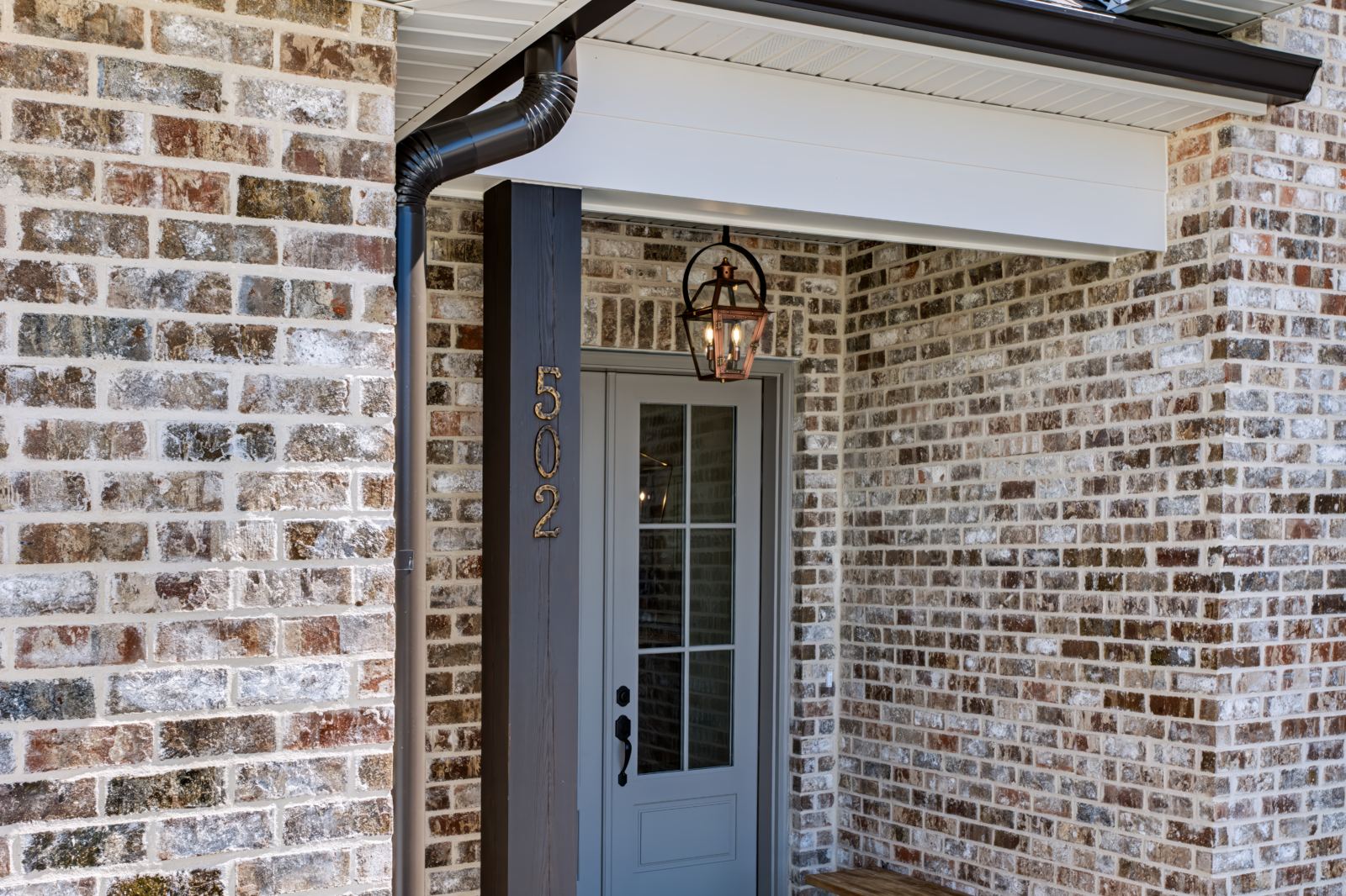 Brick entry with copper gas lantern