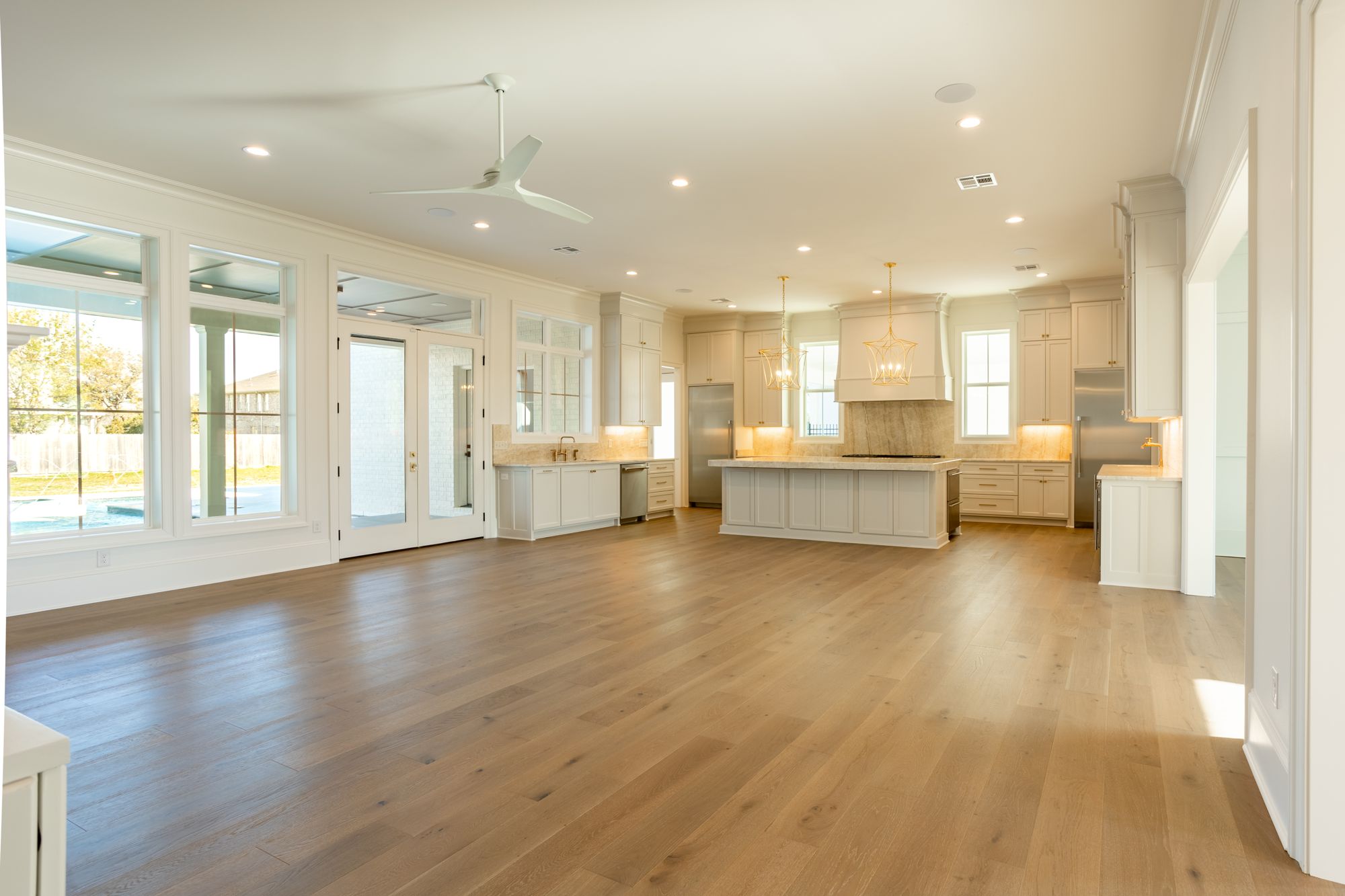 Sun-filled open living room and kitchen with wide-plank oak floors