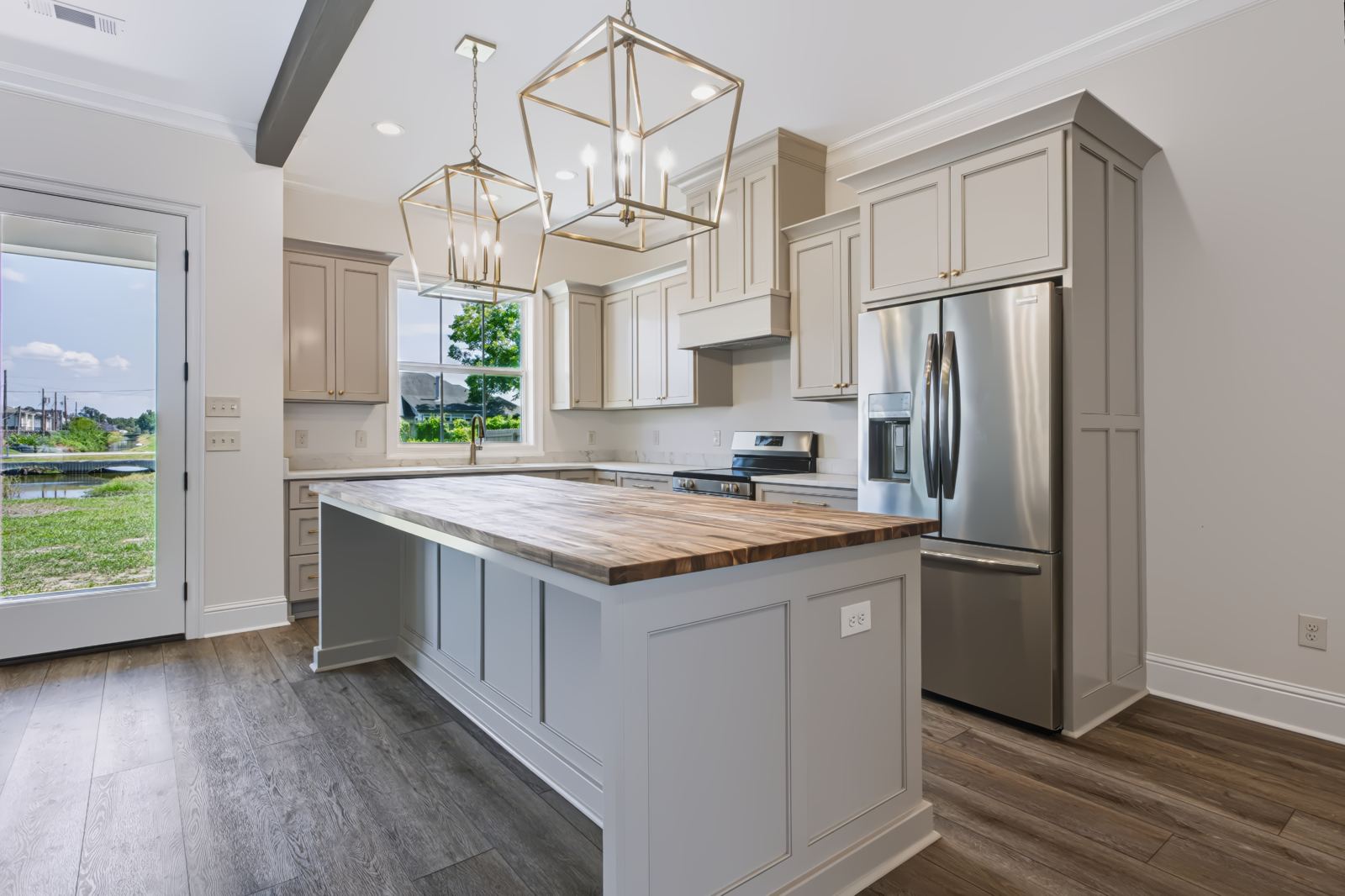 Kitchen with butcher-block island and brass fixtures