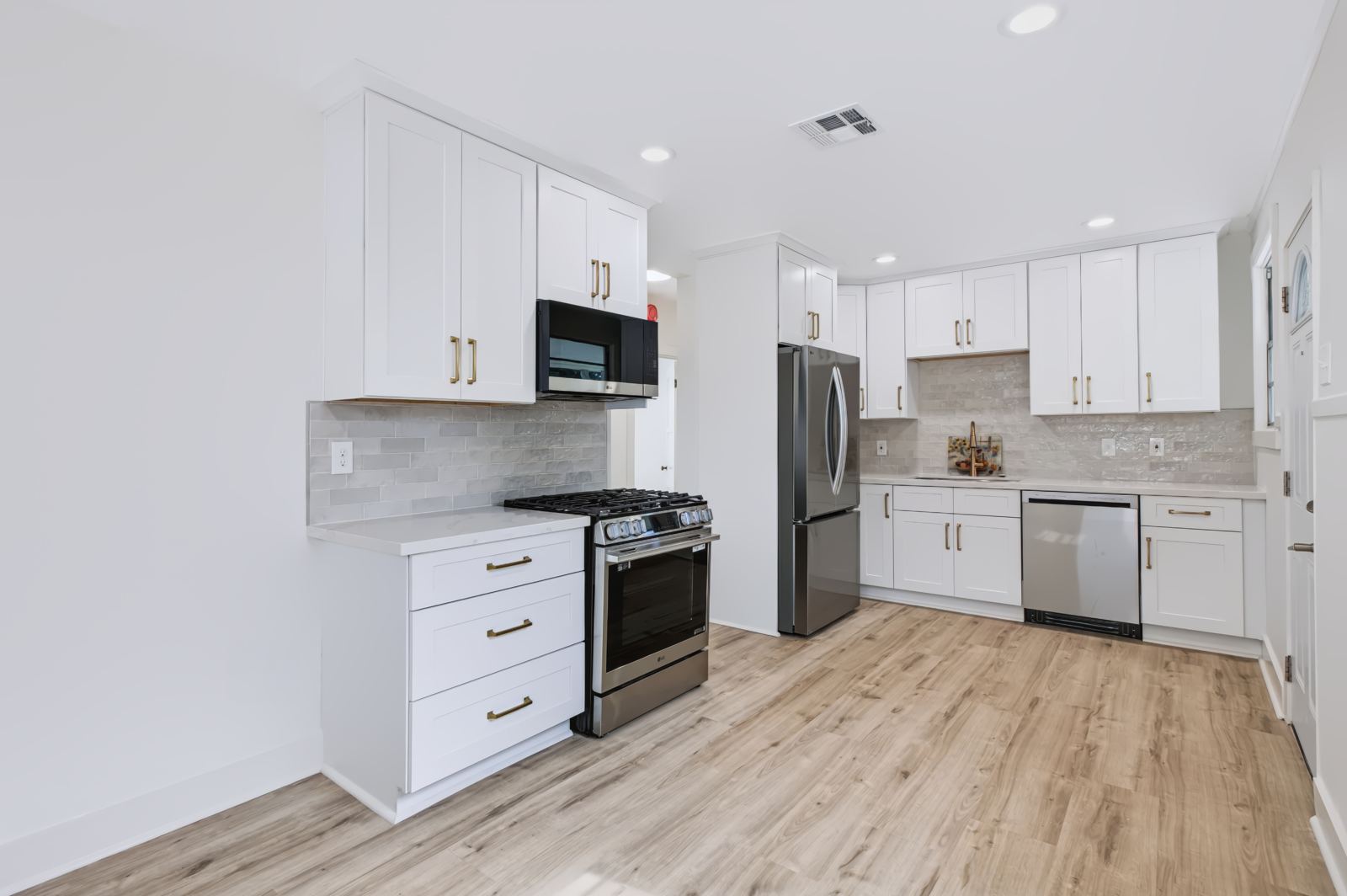 Renovated white kitchen with stainless appliances